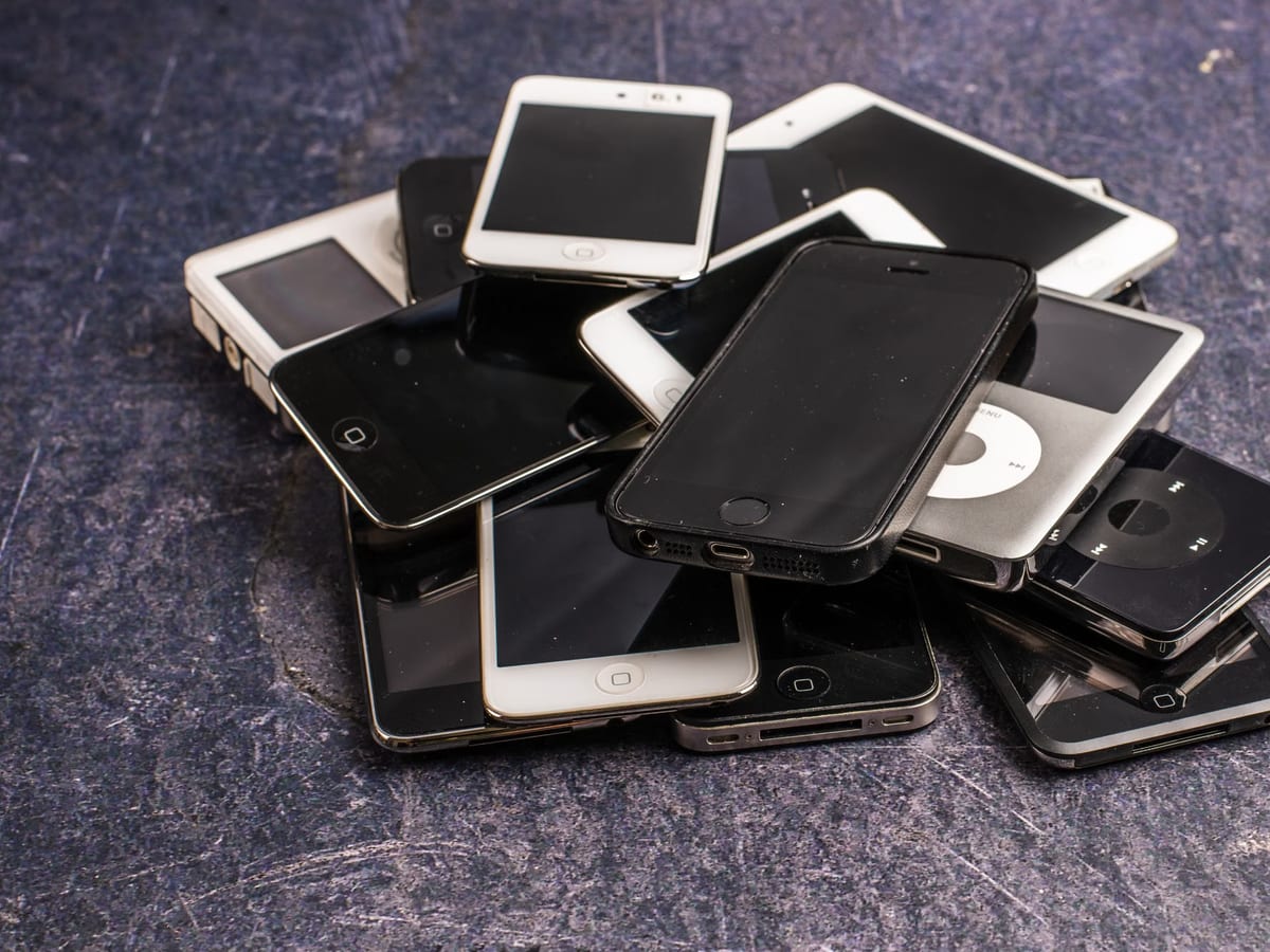 A pile of traded-in phones, tablets and media players waiting to be booked in